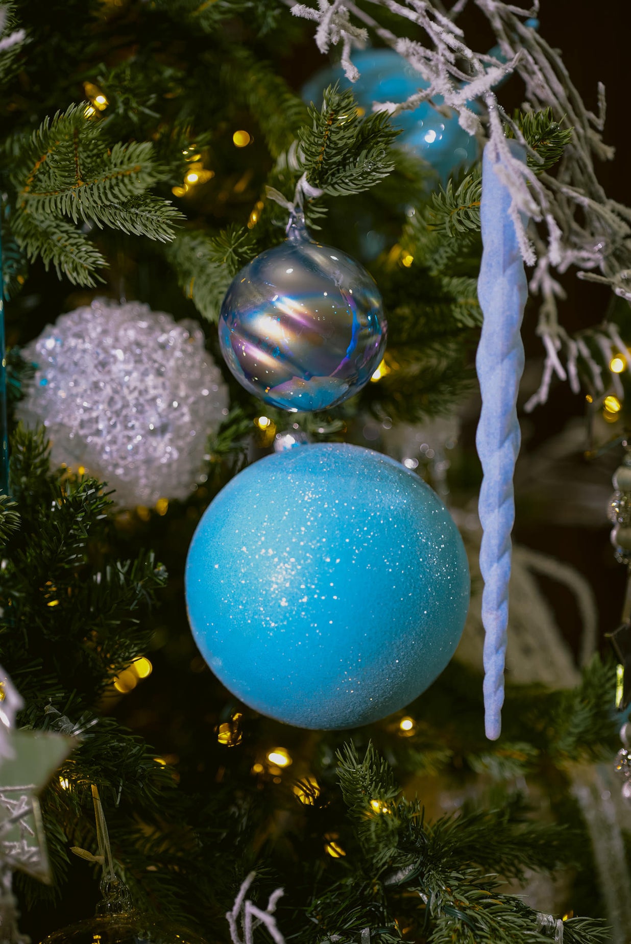 blue and silver Christmas tree - close up of glittery blue ornament and icicle ornament 
