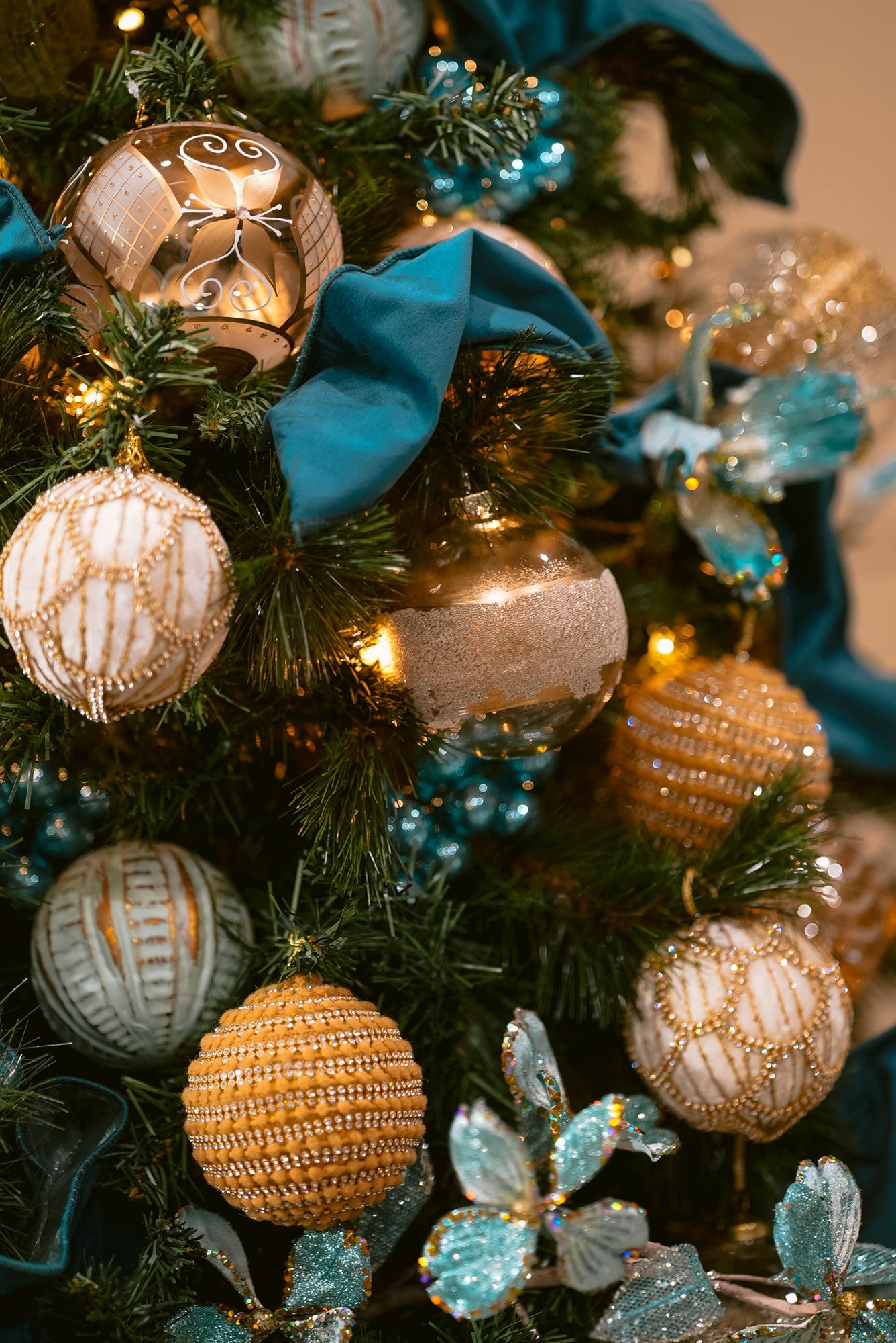 Teal and Gold Christmas Tree close up of gold ornaments and teal ribbon